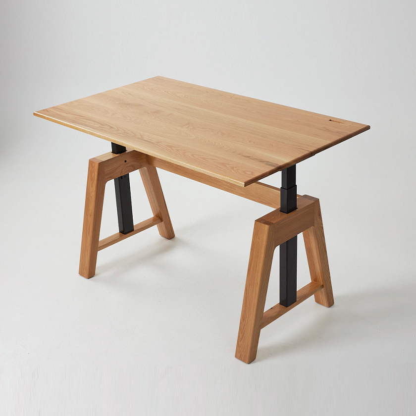 A modern timber standing desk made in Oak timber with black legs