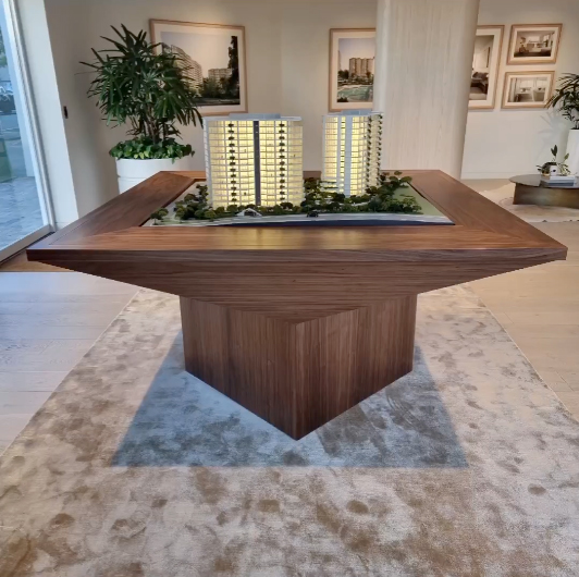 Custom made timber table with a building model sitting in a dispaly office